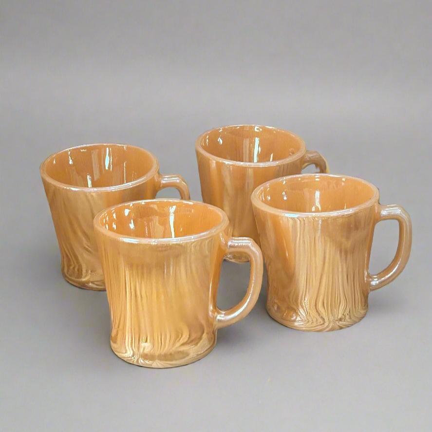 four orange luster mugs