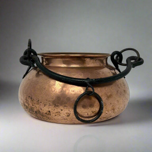 Small copper cauldron with black metal handle