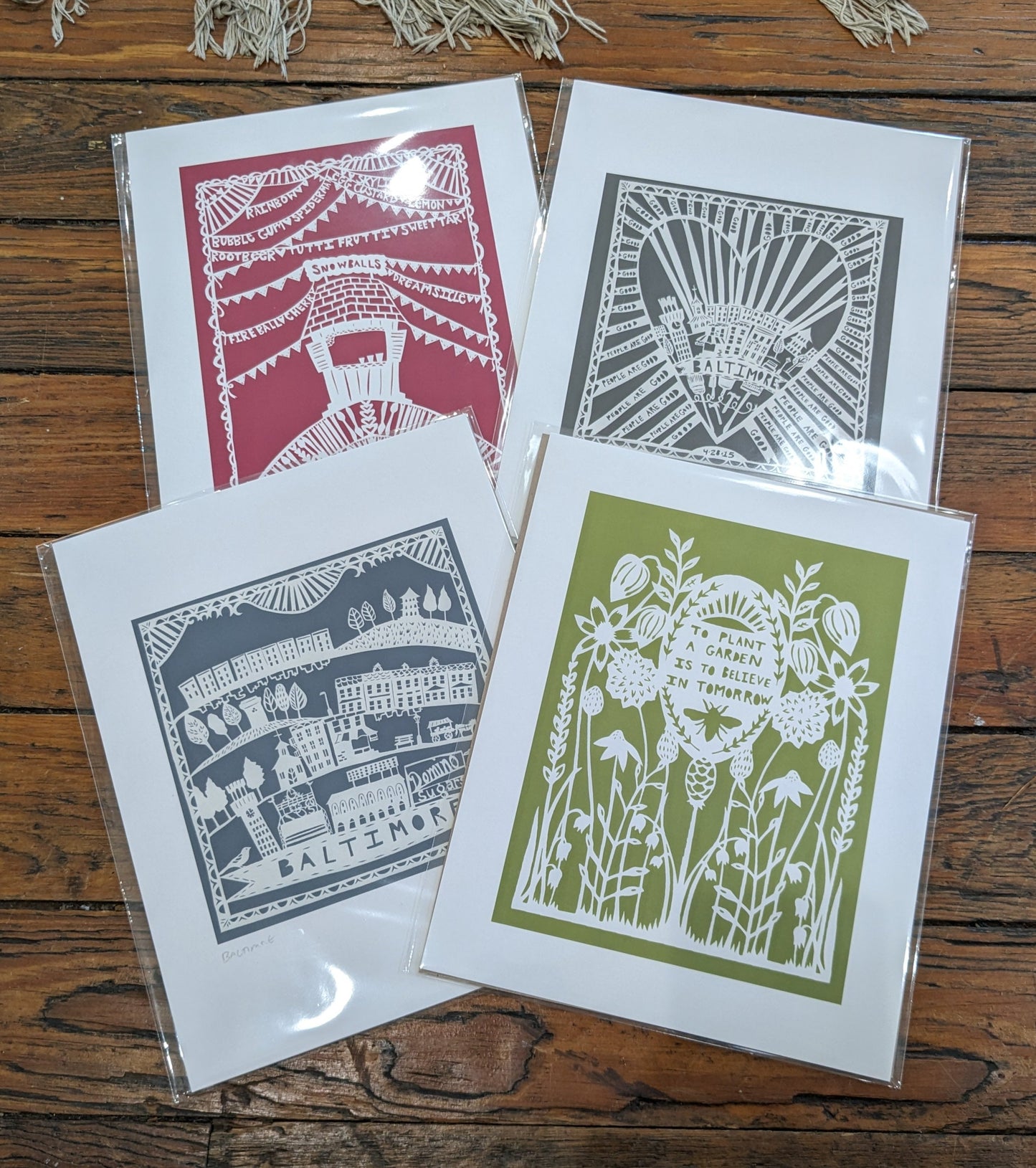 White papercuts on matte colored backgrounds, various themes