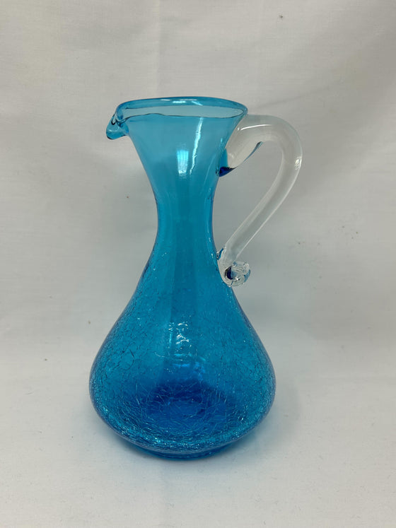 Artfully cracked translucent turquoise plastic body with clear handle, 7.5-inch height