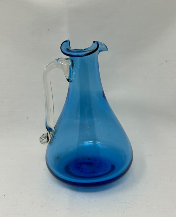 Blue, blown glass pitcher with clear handle and ripple-wave rim shape, 4.5-inch height