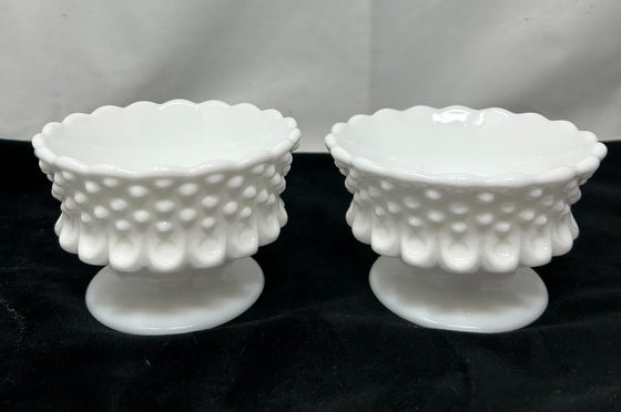 Pair of white milk glass hobnail candle votive holders, stoutly stemmed with scalloped edges