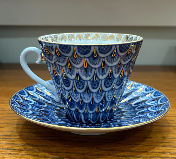 Russian porcelain tea cup and saucer, blue scale design with gold embellishments