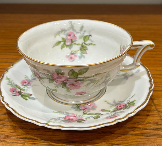 Haviland Limoges tea cup and saucer, pink rose design on white background with gold edging