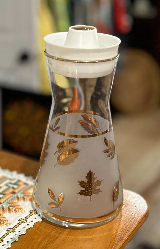 Frosted glass juice carafe with gold leaf pattern and gold rim, white lid