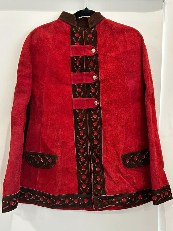 Red suede poncho, unlined, black cut-out pattern along hem and pockets, 3 fold-over button closures