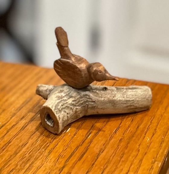 Carved miniature wren on branch, light wood branch, warm medium wood wren
