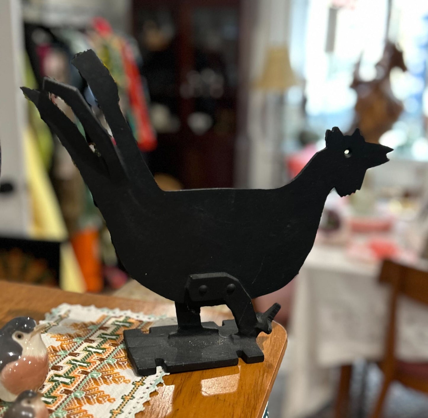 Black cast iron boot scraper shaped like a 2D rooster