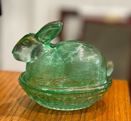 Covered glass dish depicting a rabbit (lid) sitting in a basket (base)