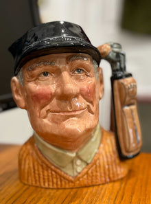  "The Golfer" mug, white male face depicted on body of mug, golf clubs/bag depicted on mug handle