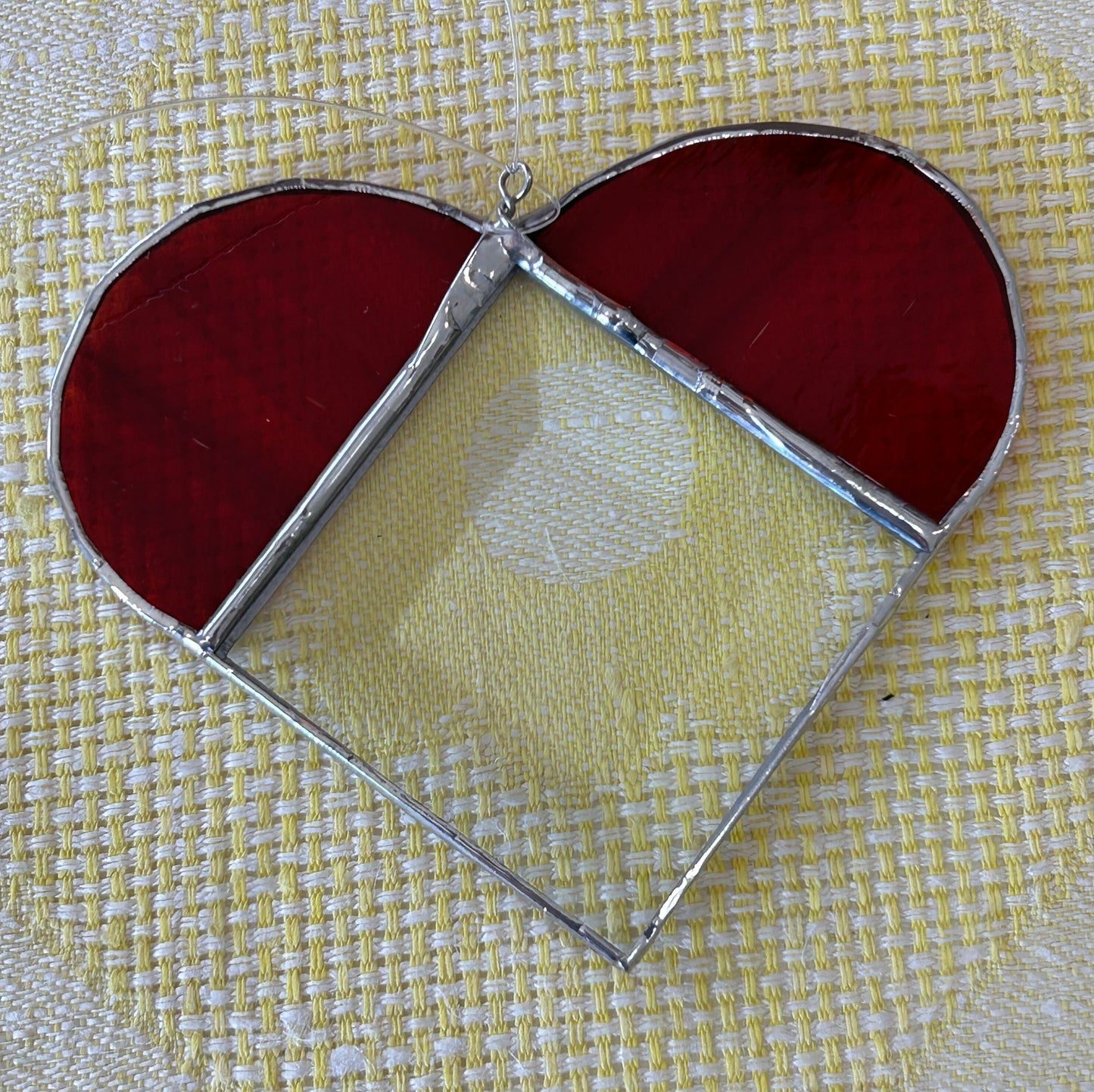 Squat heart: Stained glass heart with two red sections and one transparent, diamond-shaped, beveled section