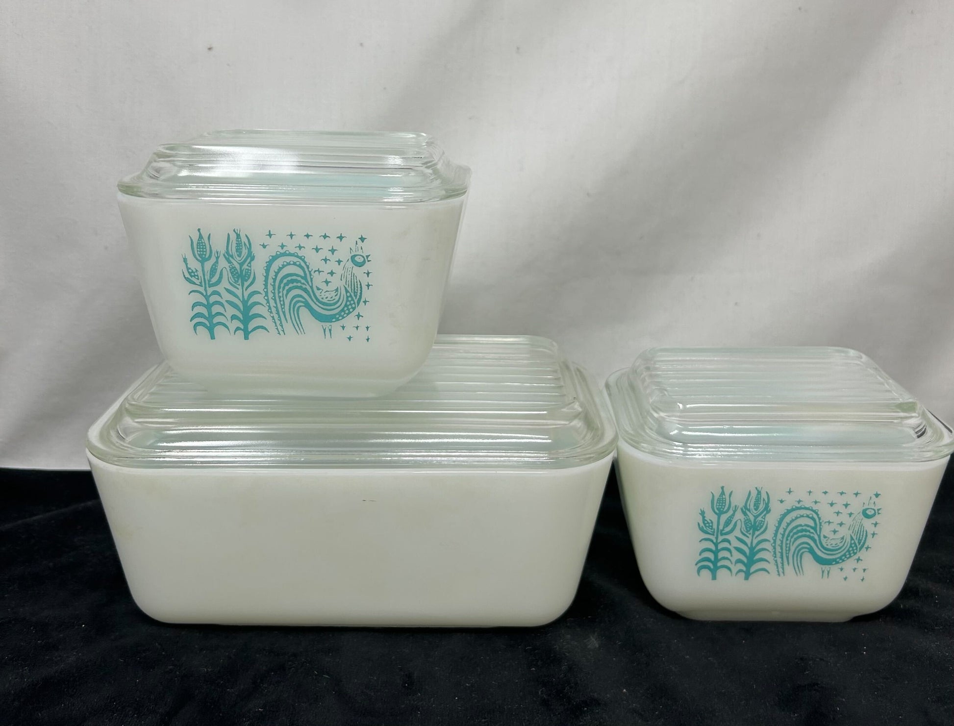 Three-piece Pyrex dishes—white base with turquoise design, clear glass top (side view)