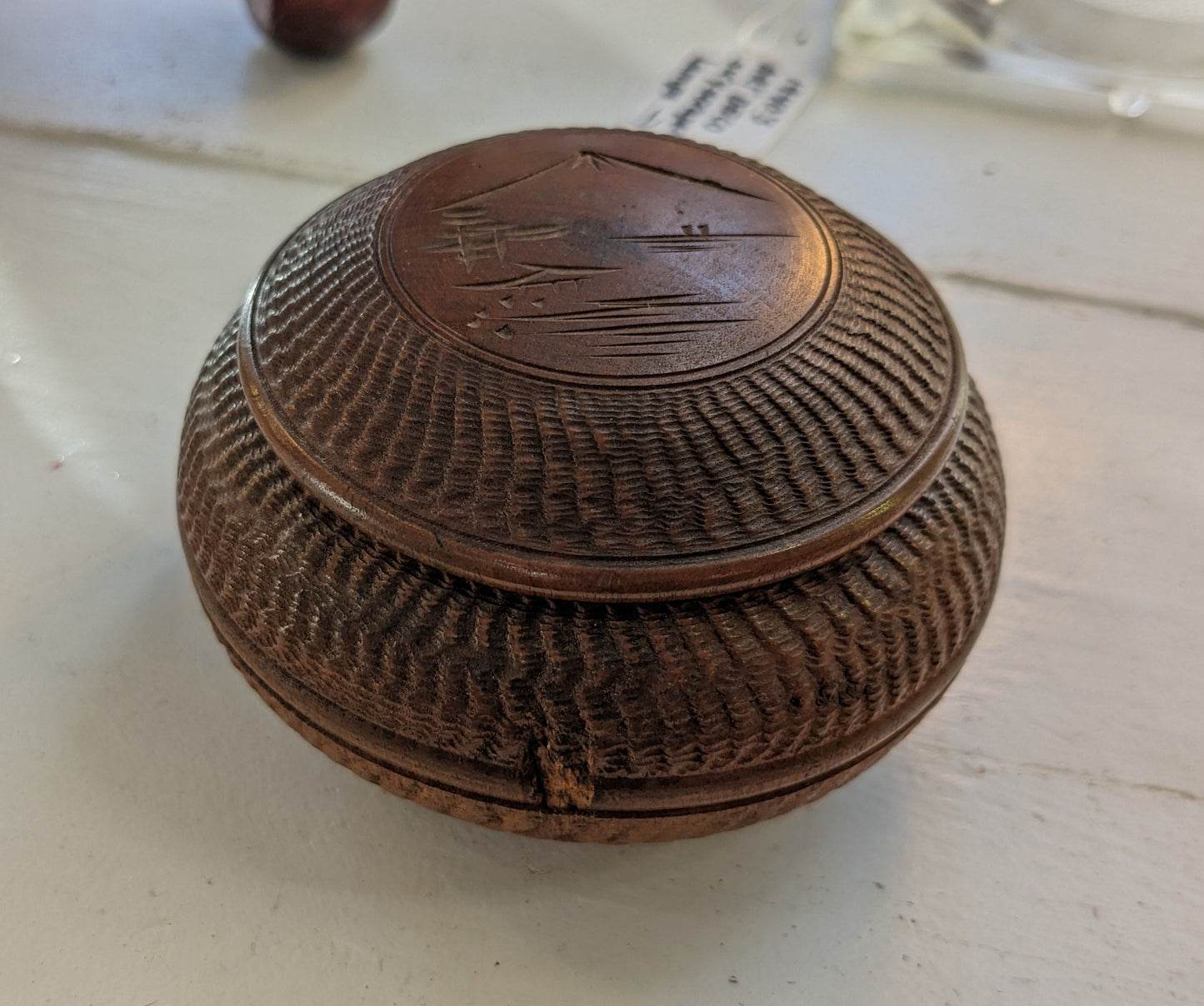 Round box with lid, textured carvings with mountaintop etched on lid