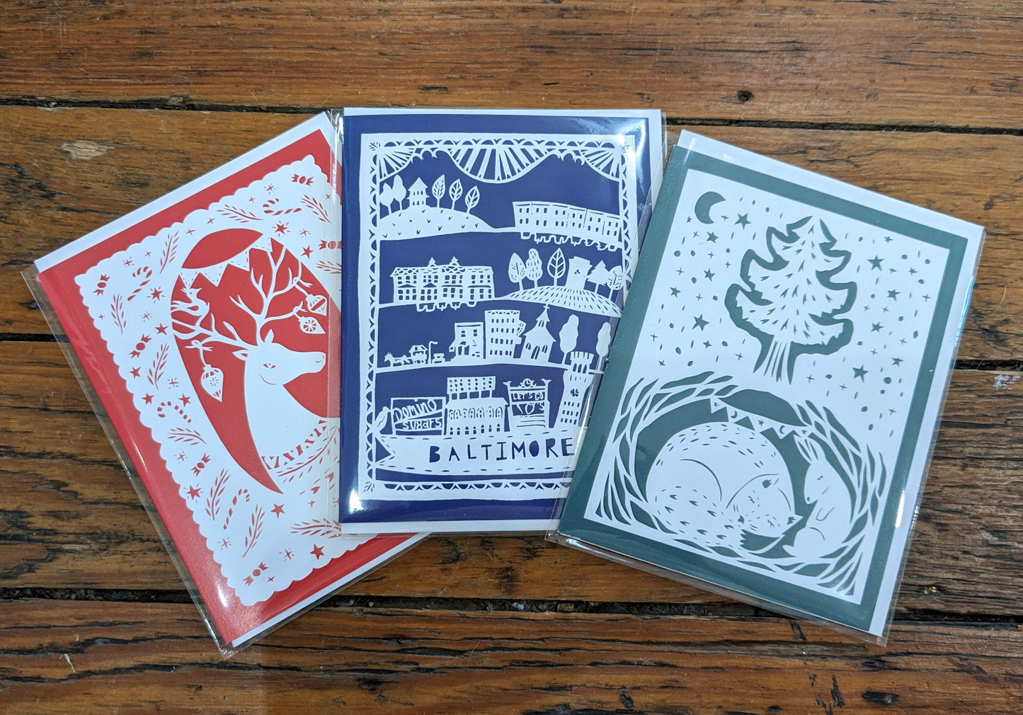 Trio of paper-cut greeting cards