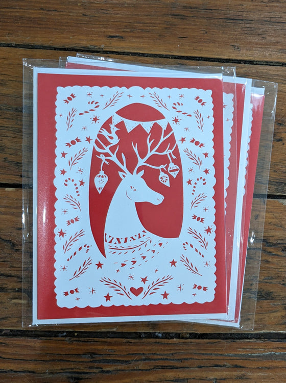 Reindeer portrait white paper-cut on red background