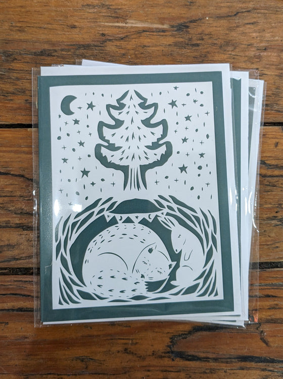 Burrowing fox white paper-cut on green background