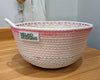 White rope basket with purple and pink threading and a cute loop handle
