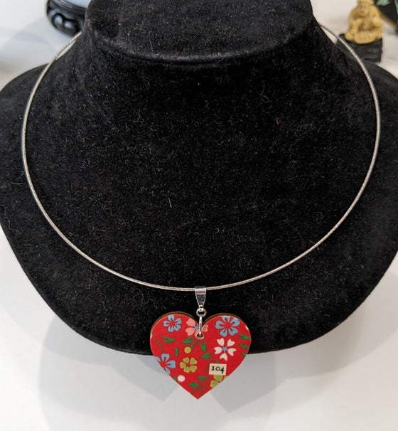 Round band necklace with heart-shaped pendant featuring floral design on red background, #104 (sonnet)
