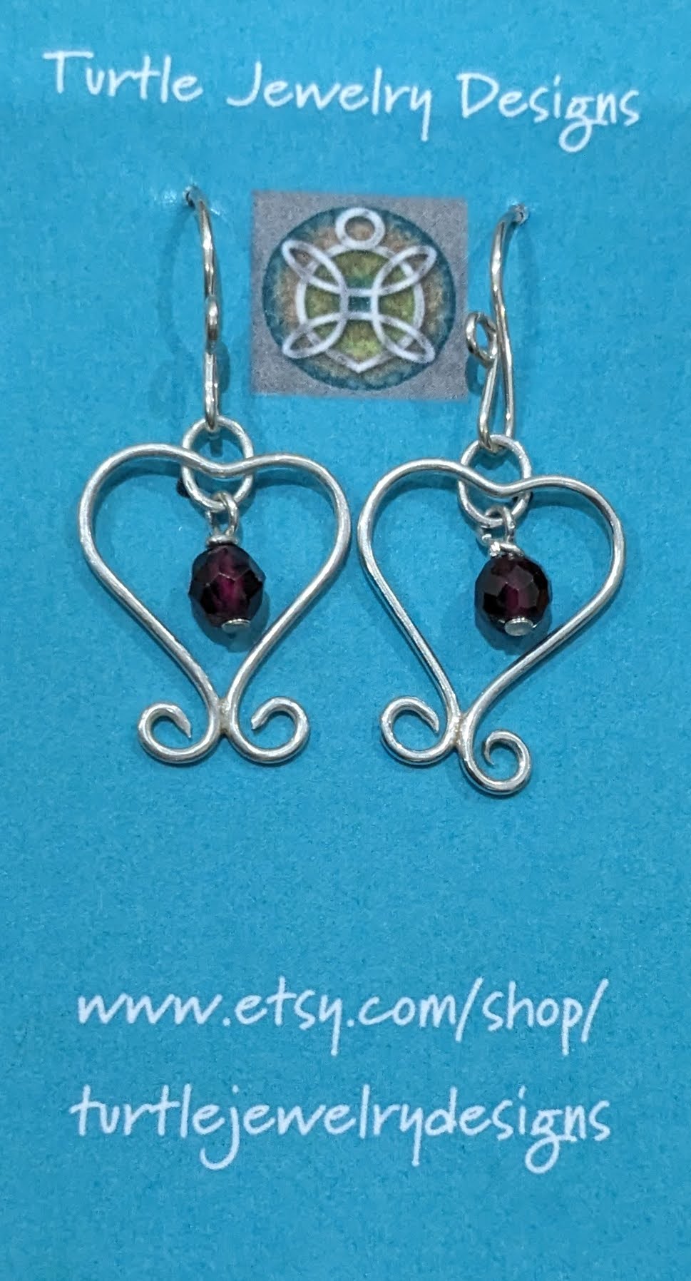 Silver wire heart earrings with garnet drops