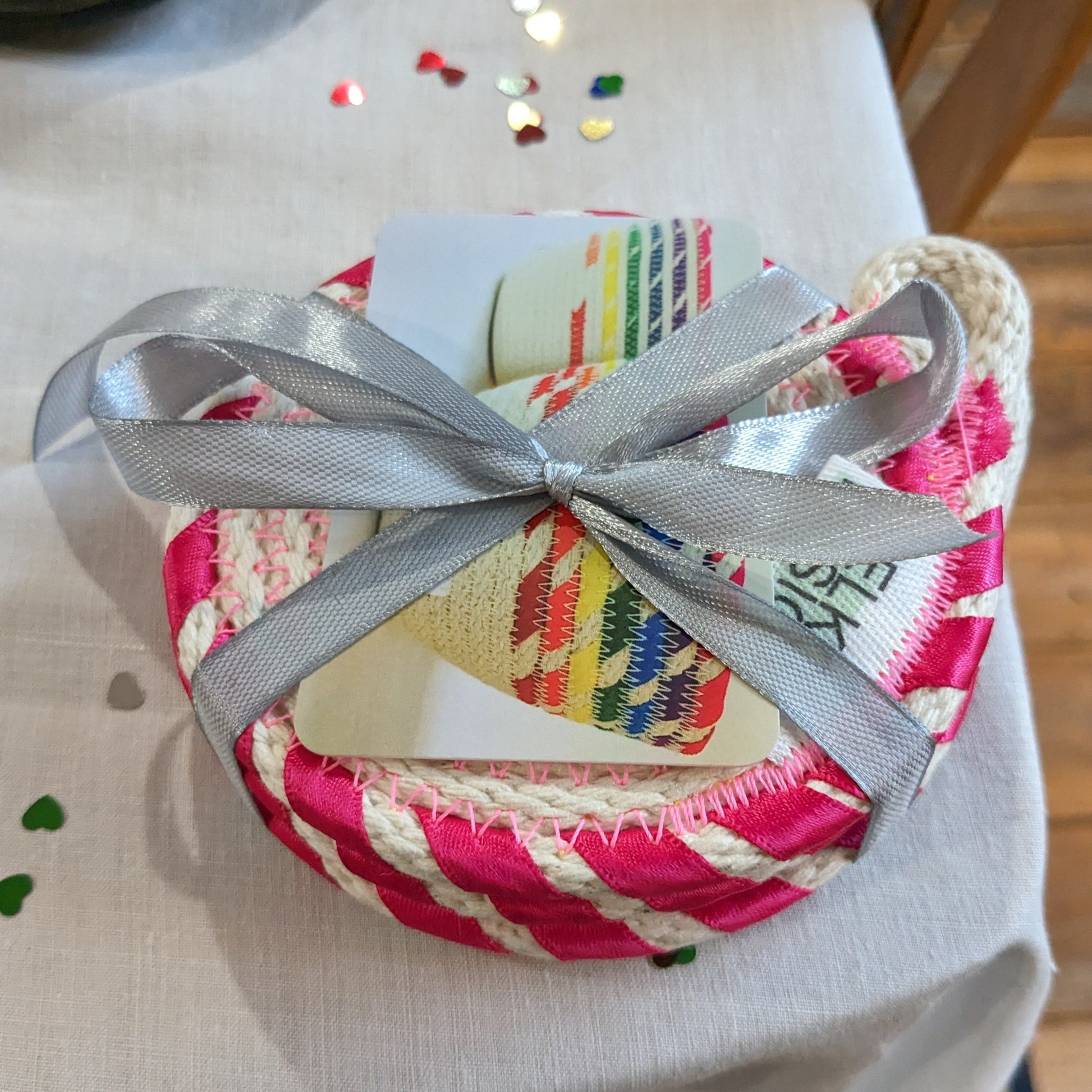 Set of four coasters with ping-edging, tied with silver ribbon, containing a Melko Designs business card