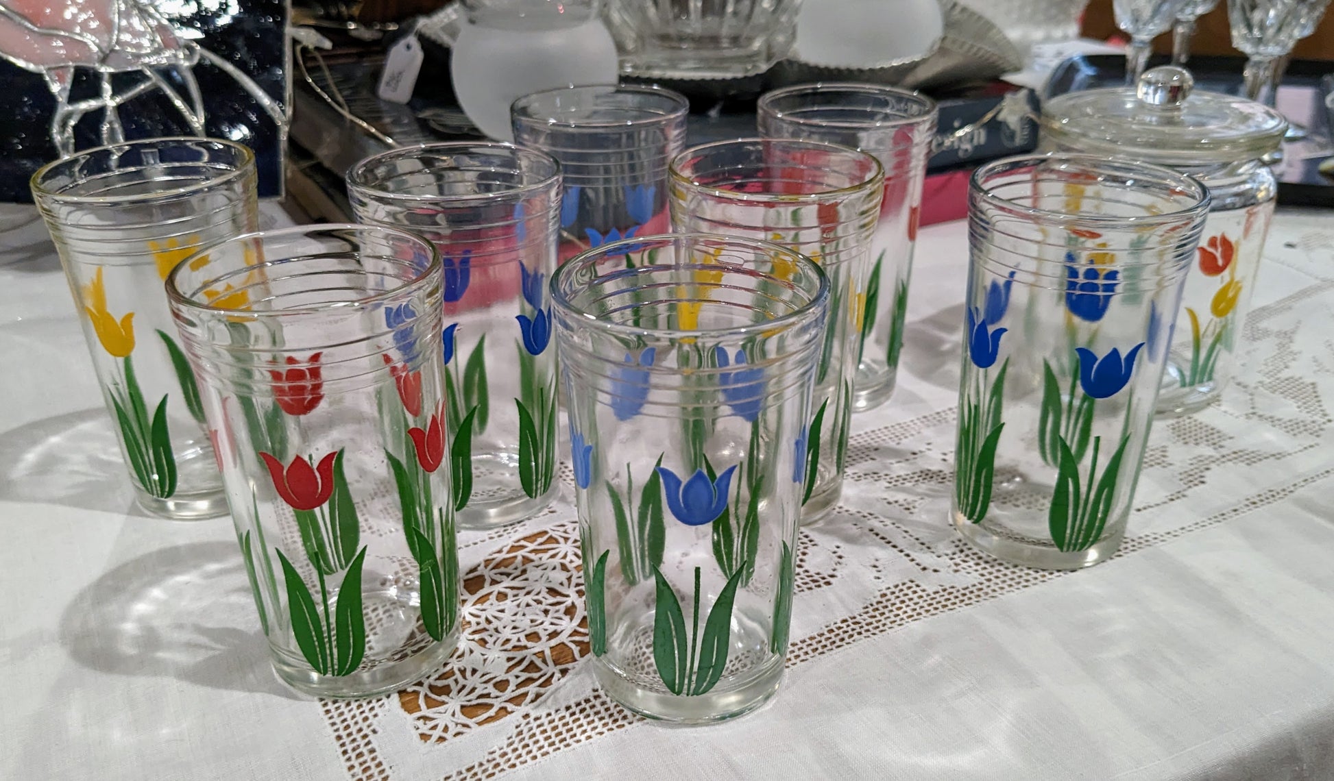  two glasses per tulip color (light blue, dark blue, red, yellow) with jar featuring red and yellow tulips