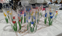   two glasses per tulip color (light blue, dark blue, red, yellow) with jar featuring red and yellow tulips