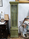 Slim curio cabinet with two glass shelves and bottom solid door cabinet with key. Green with white trim