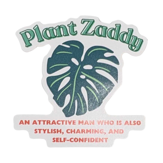 Sticker with single green monstera leaf in center with "Plant Zaddy" above in green text, and description of a "Plant Zaddy" below in smaller red text.